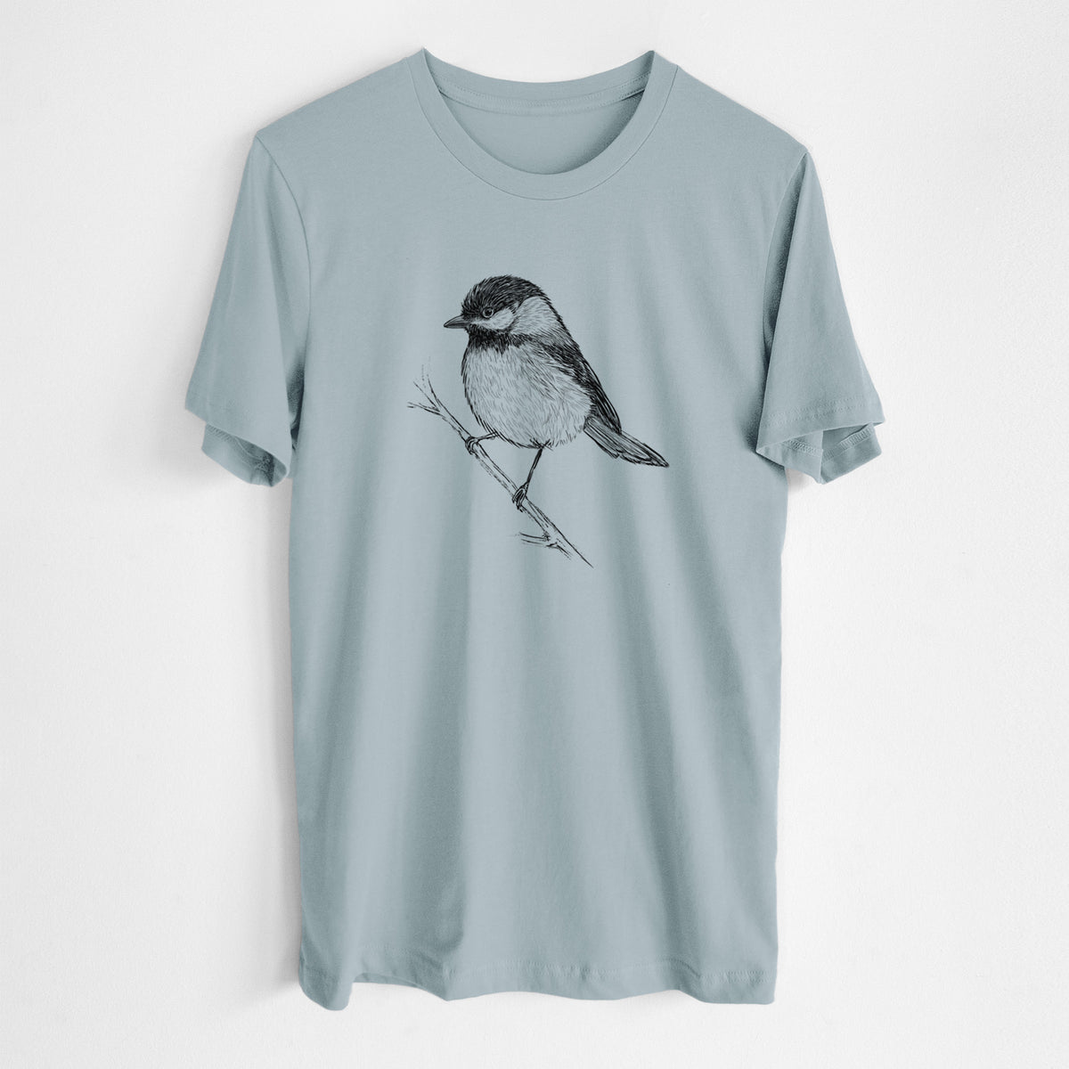 Vintage denim lightweight cotton t-shirt laid flat, printed with a detailed black ink sketch of a black-capped chickadee perched on a branch.