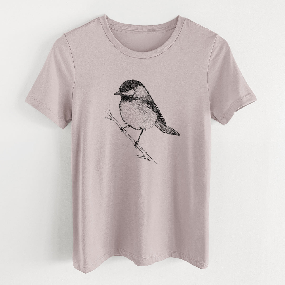 Pink gravel women's relaxed fit cotton t-shirt laid flat, printed with a detailed black ink sketch of a black-capped chickadee perched on a branch.
