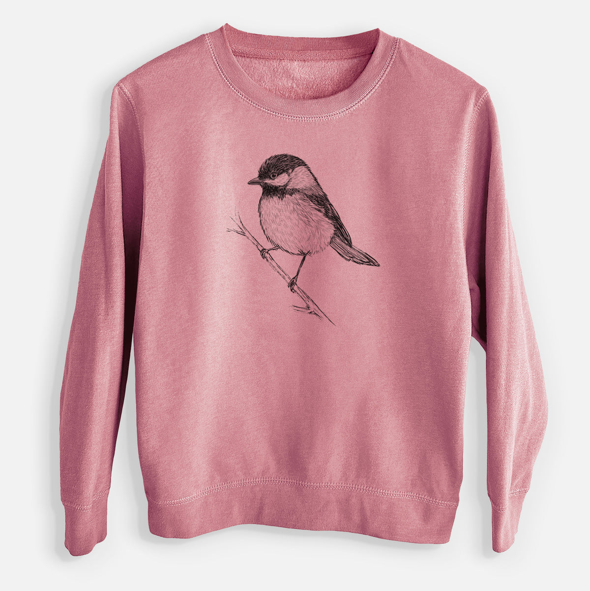 Mauve pink youth crewneck sweatshirt laid flat, printed with a detailed black ink sketch of a black-capped chickadee perched on a branch.