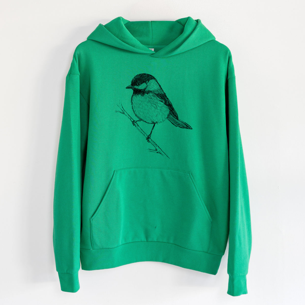 Black-capped Chickadee - Poecile atricapillus - Statement Midweight Hoodie in Kelly Green, hanging on a white wall, with a front kangaroo pocket and no drawcords.