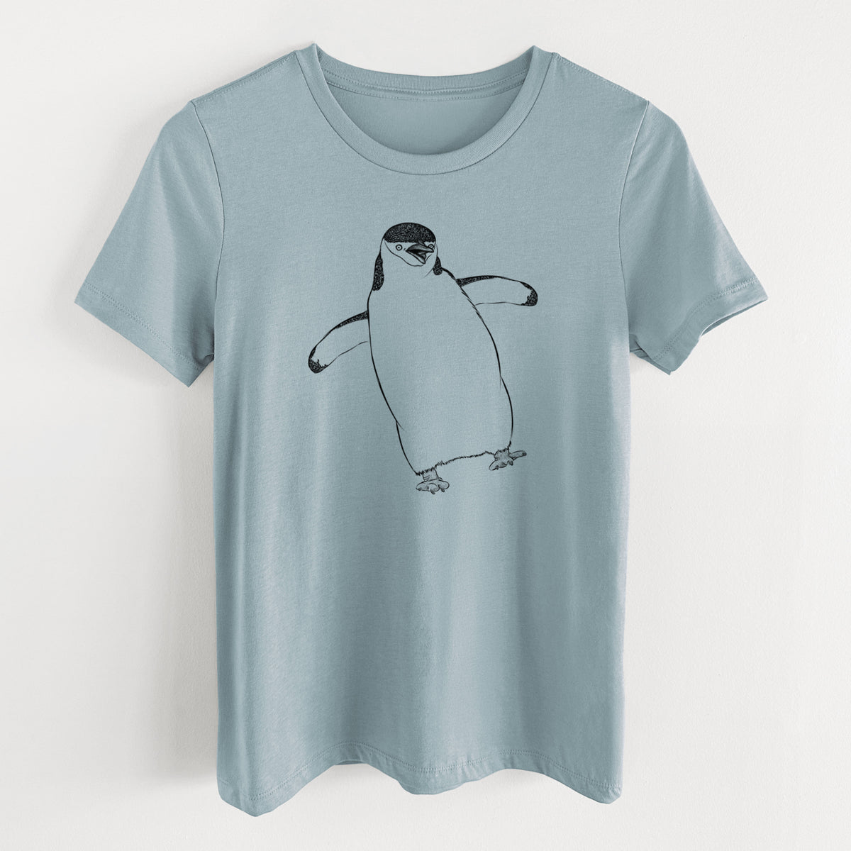 Vintage denim women's relaxed fit cotton t-shirt laid flat, printed with a black ink illustration of a chinstrap penguin standing with its flippers out.