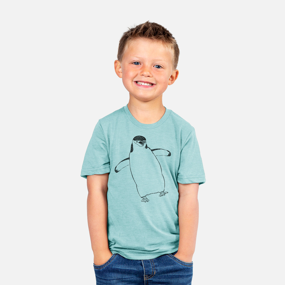 Smiling boy wearing a youth t-shirt printed with a black ink illustration of a chinstrap penguin standing with its flippers out.