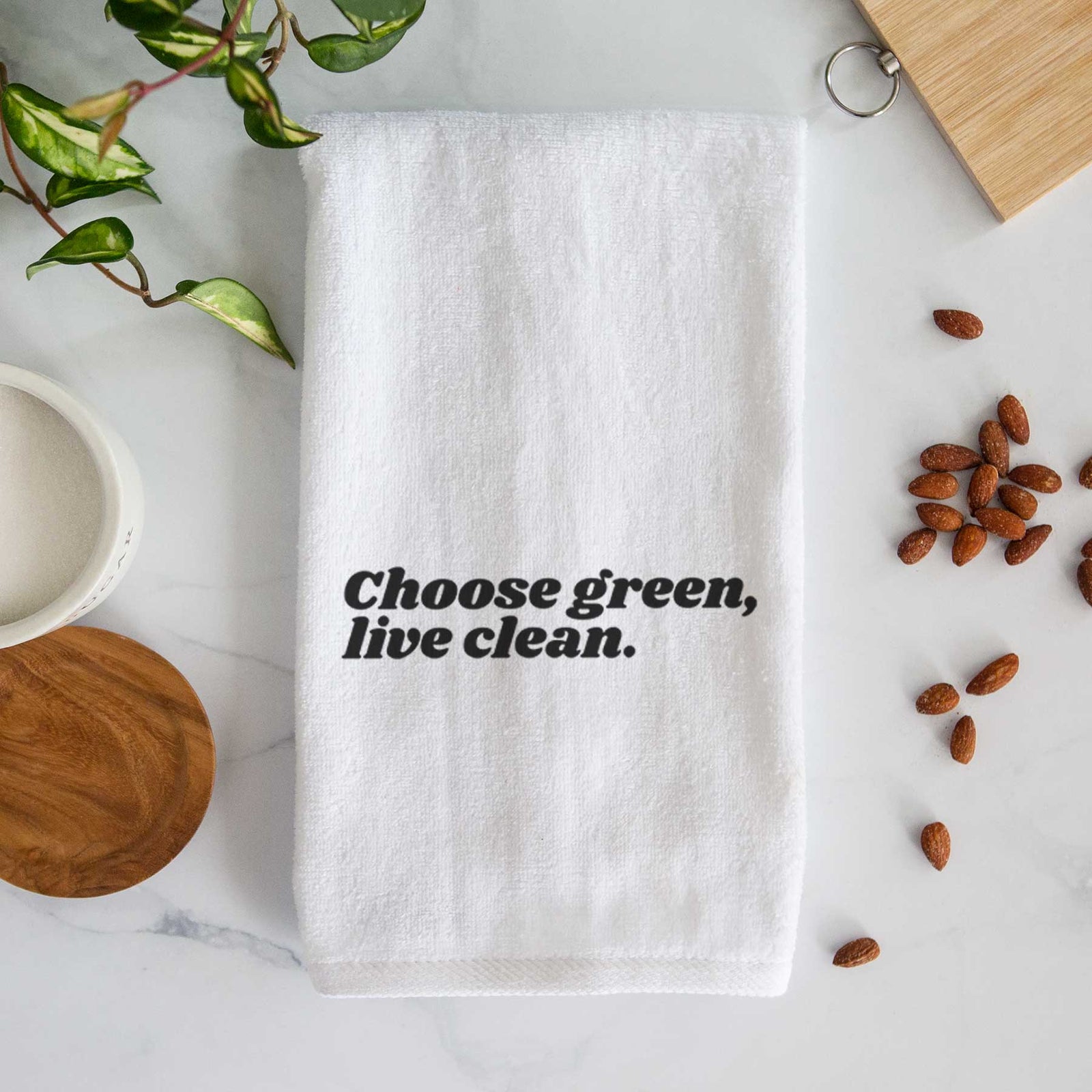 White hand towel printed with small black script words reading Choose Green, Live Clean on the upper chest.