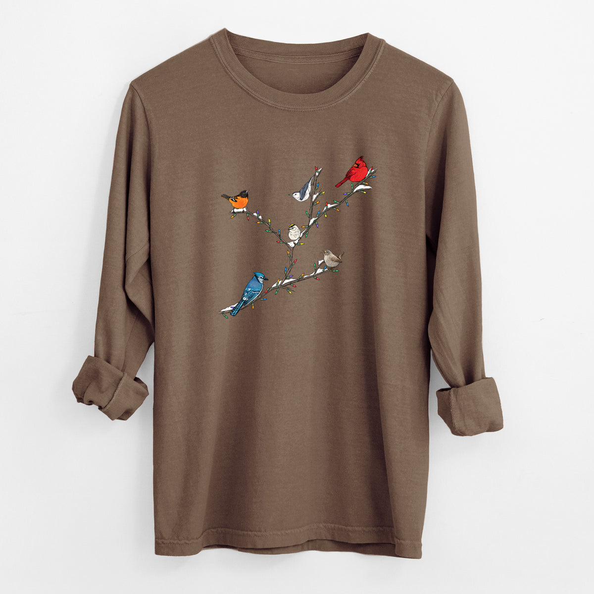 Espresso brown Comfort Colors long sleeve shirt laid flat with the cuffs rolled, printed with a full-color illustration of winter backyard birds, including a cardinal, blue jay and robin, perched on bare branches.