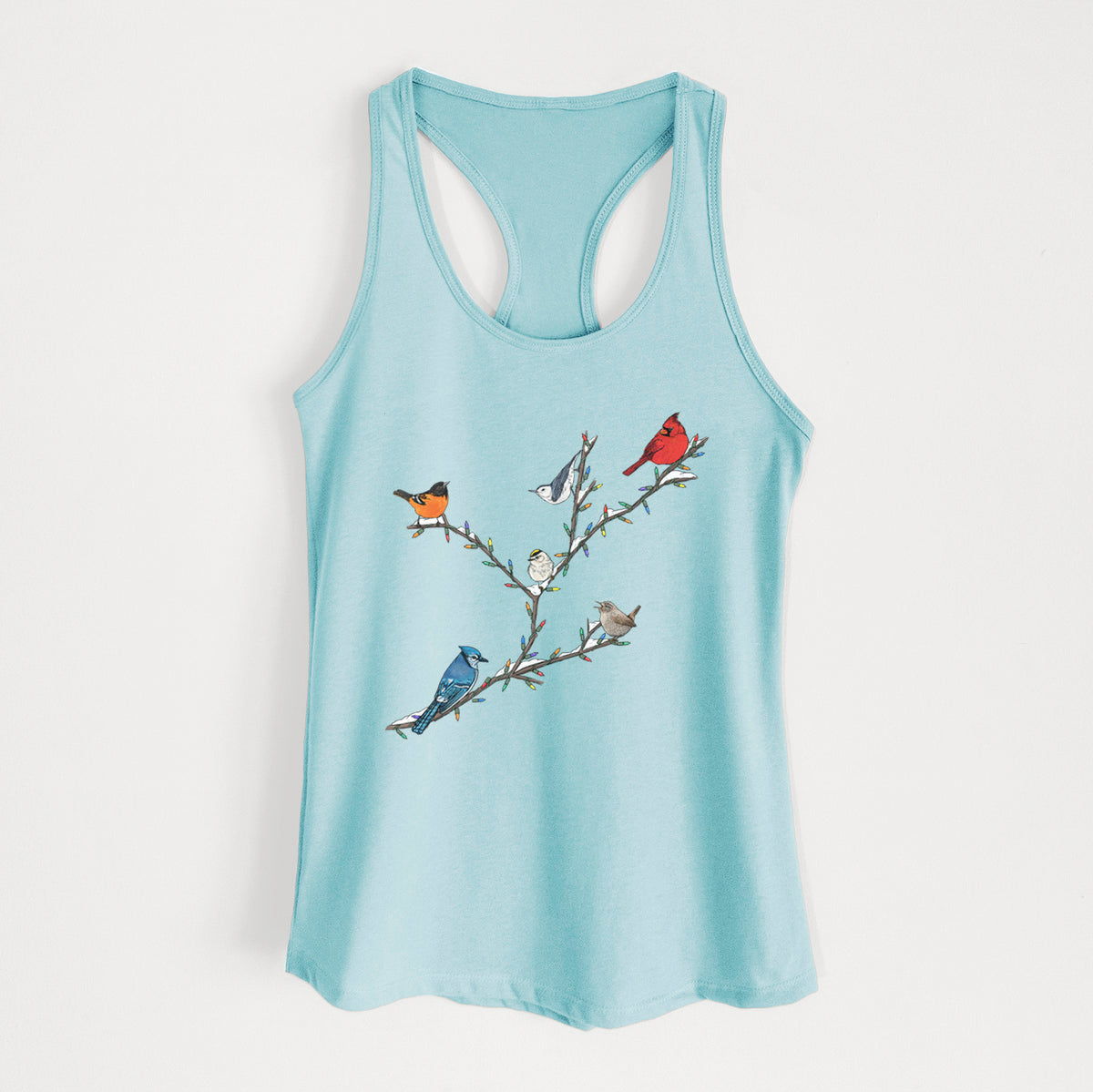 Cancun blue women's racerback tank top laid flat, printed with a full-color illustration of winter backyard birds, including a cardinal, blue jay and robin, perched on bare branches.