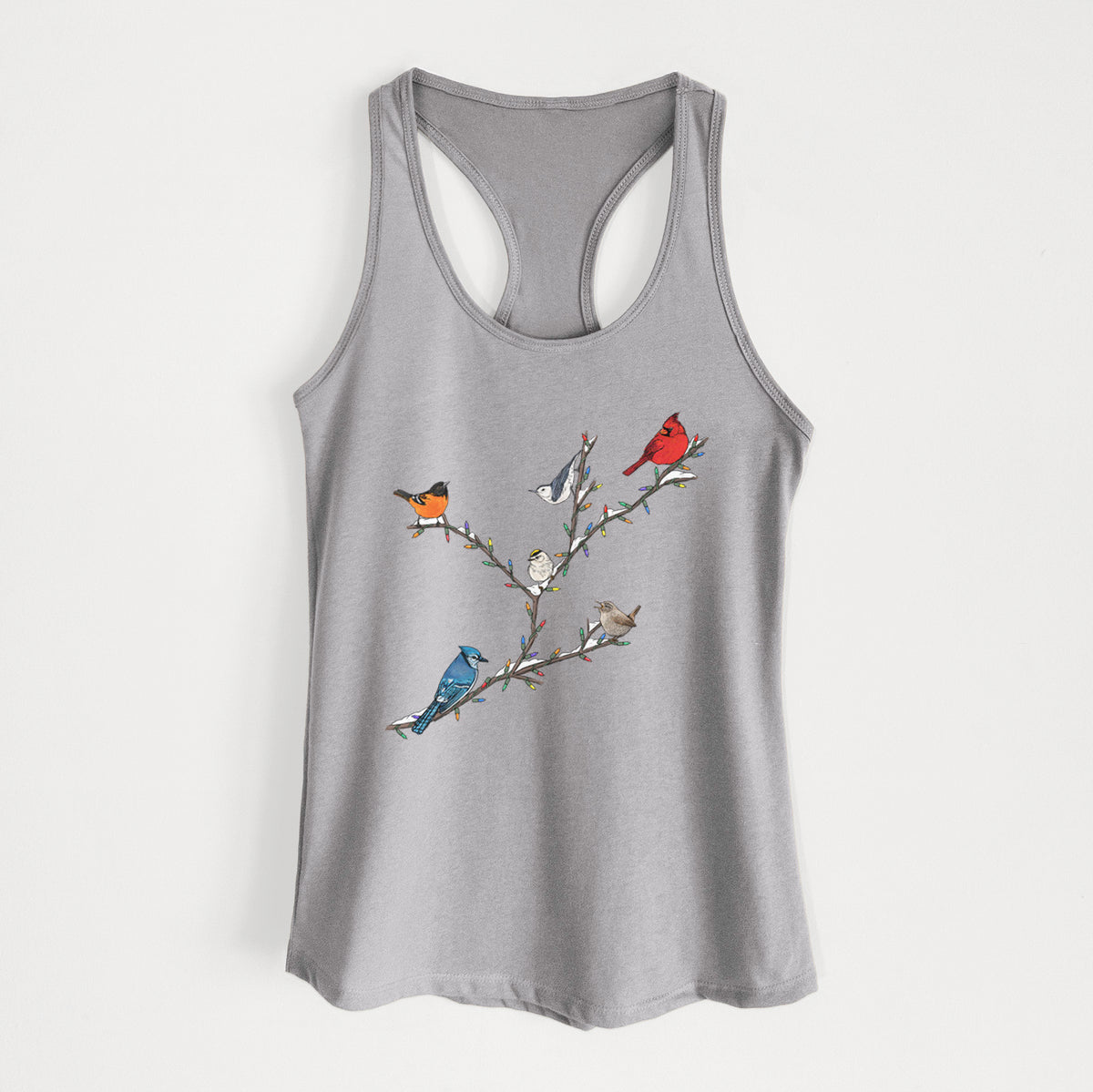 Heather grey women's racerback tank top laid flat, printed with a full-color illustration of winter backyard birds, including a cardinal, blue jay and robin, perched on bare branches.