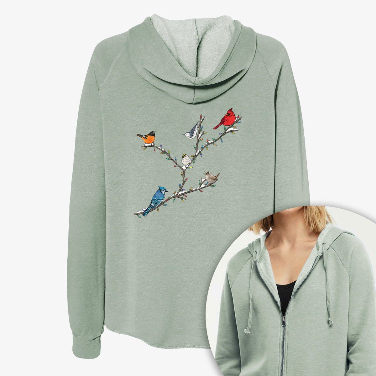Women's Cali Wave zip-up sweatshirt printed with a full-color illustration of winter backyard birds, including a cardinal, blue jay and robin, perched on bare branches, with a close-up of the zipper.