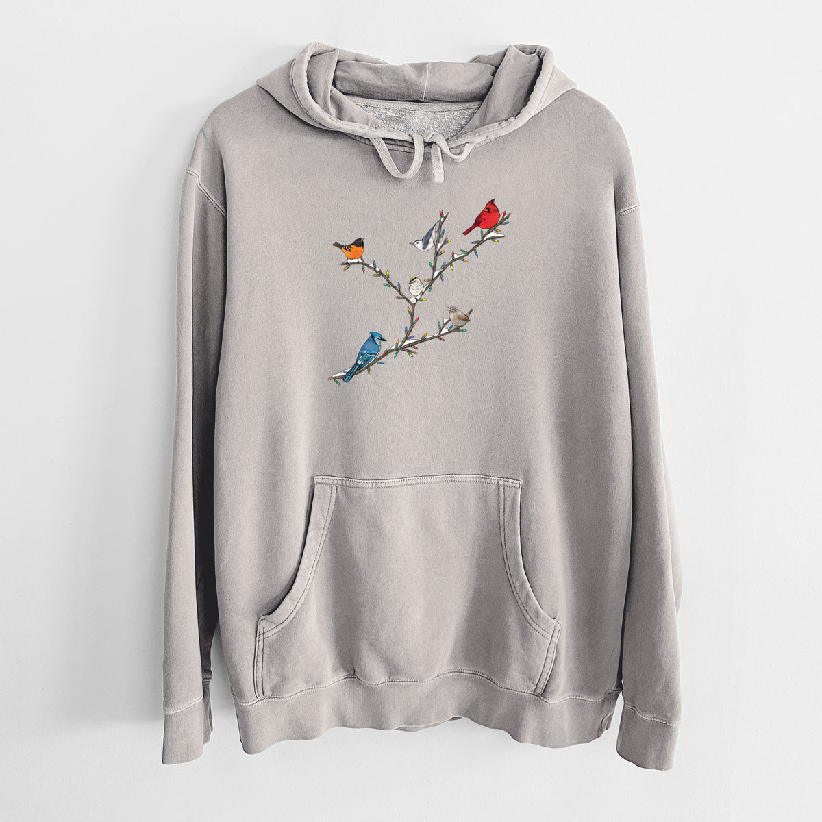 Cement grey pigment dyed hoodie laid flat, printed with a full-color illustration of winter backyard birds, including a cardinal, blue jay and robin, perched on bare branches.