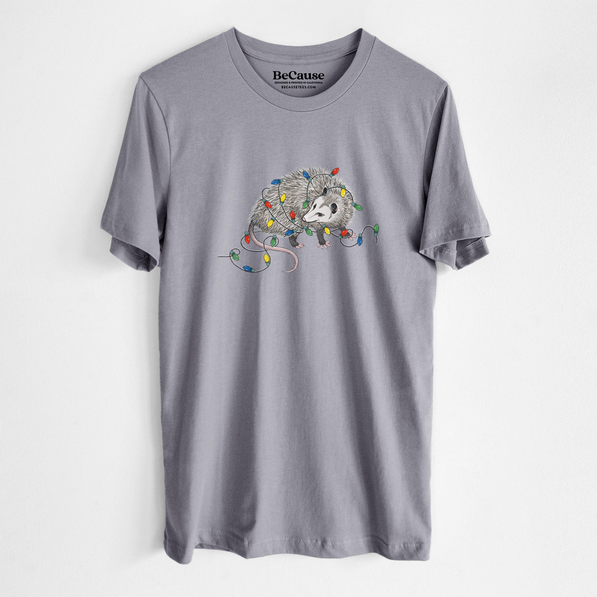 Storm grey lightweight cotton t-shirt laid flat, printed with a black ink opossum tangled in a string of colorful holiday lights.