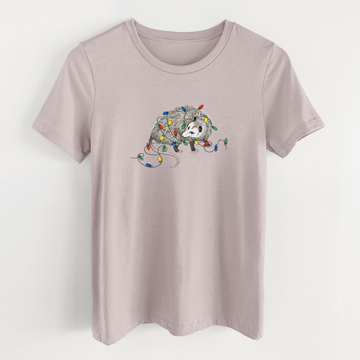 Pink gravel women's relaxed fit cotton t-shirt laid flat, printed with a black ink opossum tangled in a string of colorful holiday lights.