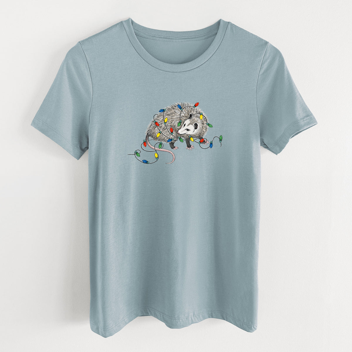 Vintage denim women's relaxed fit cotton t-shirt laid flat, printed with a black ink opossum tangled in a string of colorful holiday lights.