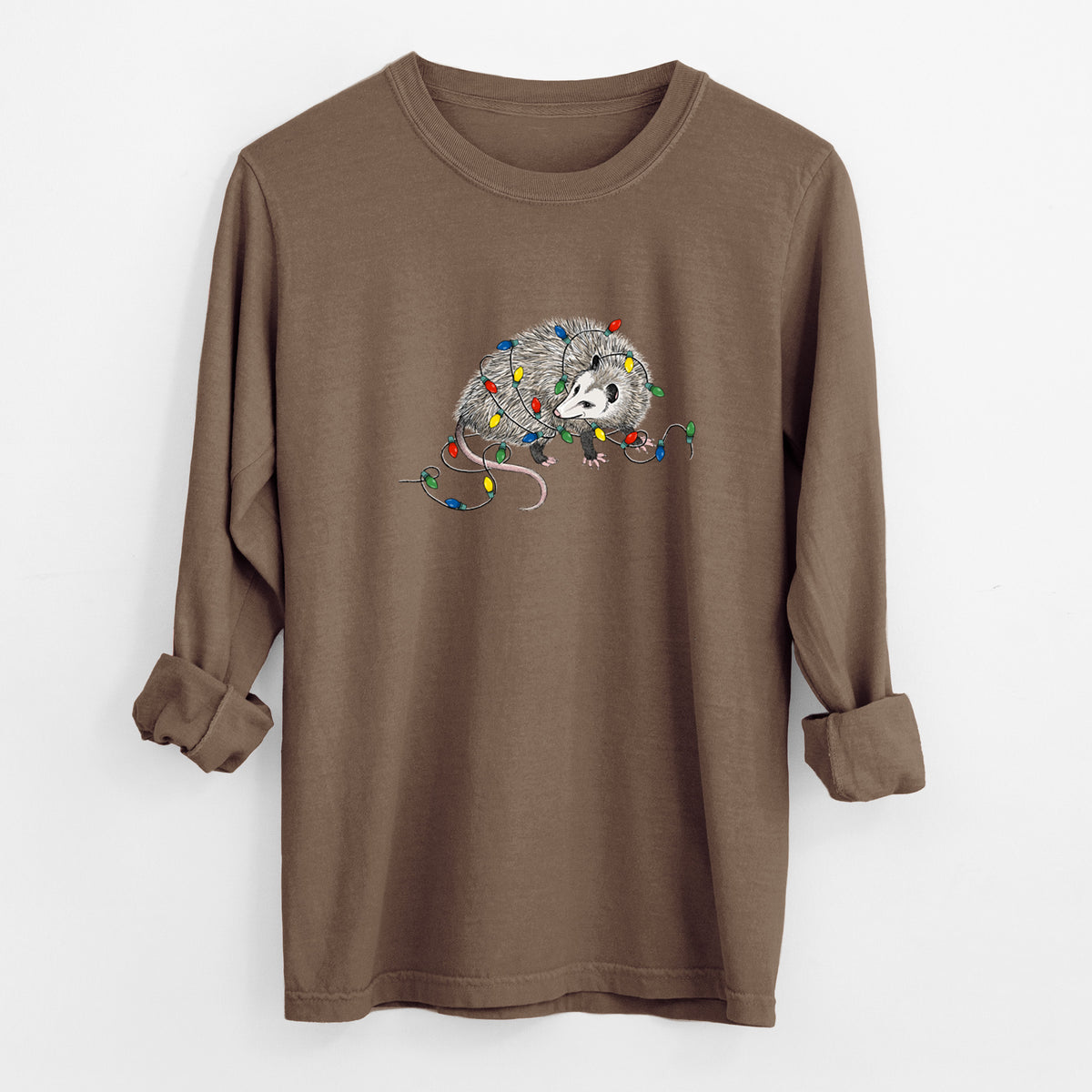 Espresso brown Comfort Colors long sleeve shirt laid flat with the cuffs rolled, printed with a black ink opossum tangled in a string of colorful holiday lights.