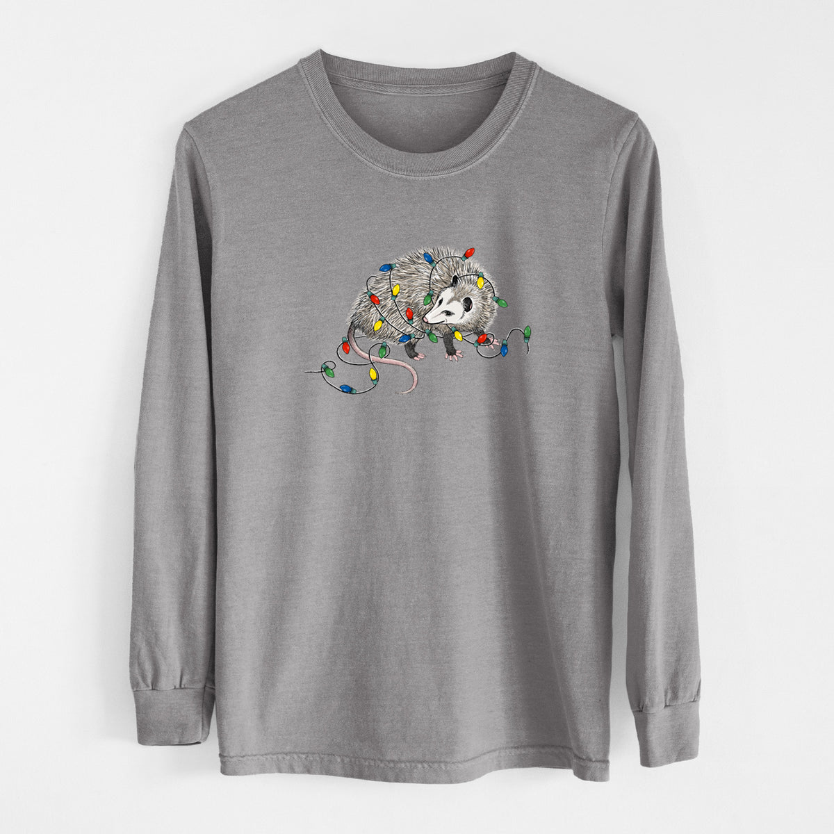 Grey Comfort Colors long sleeve shirt laid flat, printed with a black ink opossum tangled in a string of colorful holiday lights.