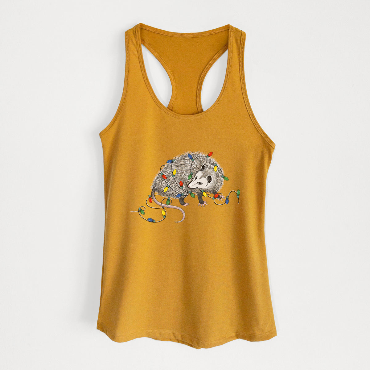 Gold women's racerback tank top laid flat, printed with a black ink opossum tangled in a string of colorful holiday lights.