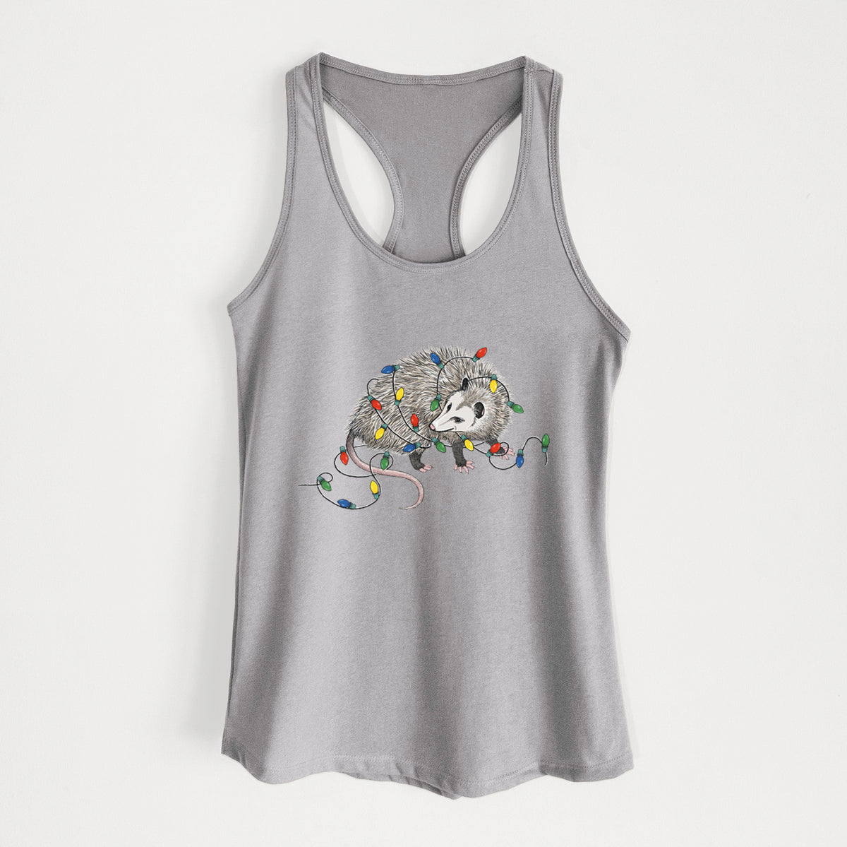 Heather grey women's racerback tank top laid flat, printed with a black ink opossum tangled in a string of colorful holiday lights.
