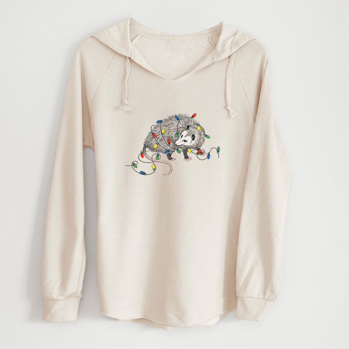 Bone cream women's Cali Wave hooded sweatshirt laid flat, printed with a black ink opossum tangled in a string of colorful holiday lights.