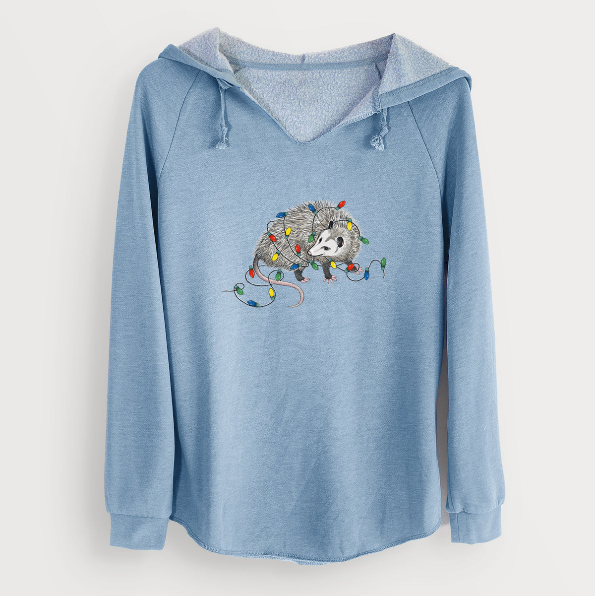 Misty blue women's Cali Wave hooded sweatshirt laid flat, printed with a black ink opossum tangled in a string of colorful holiday lights.