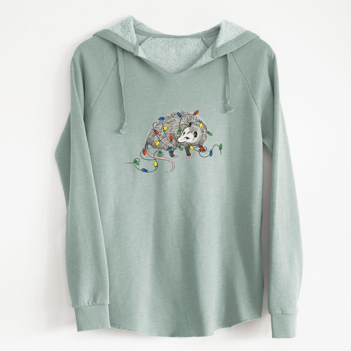Sage green women's Cali Wave hooded sweatshirt laid flat, printed with a black ink opossum tangled in a string of colorful holiday lights.