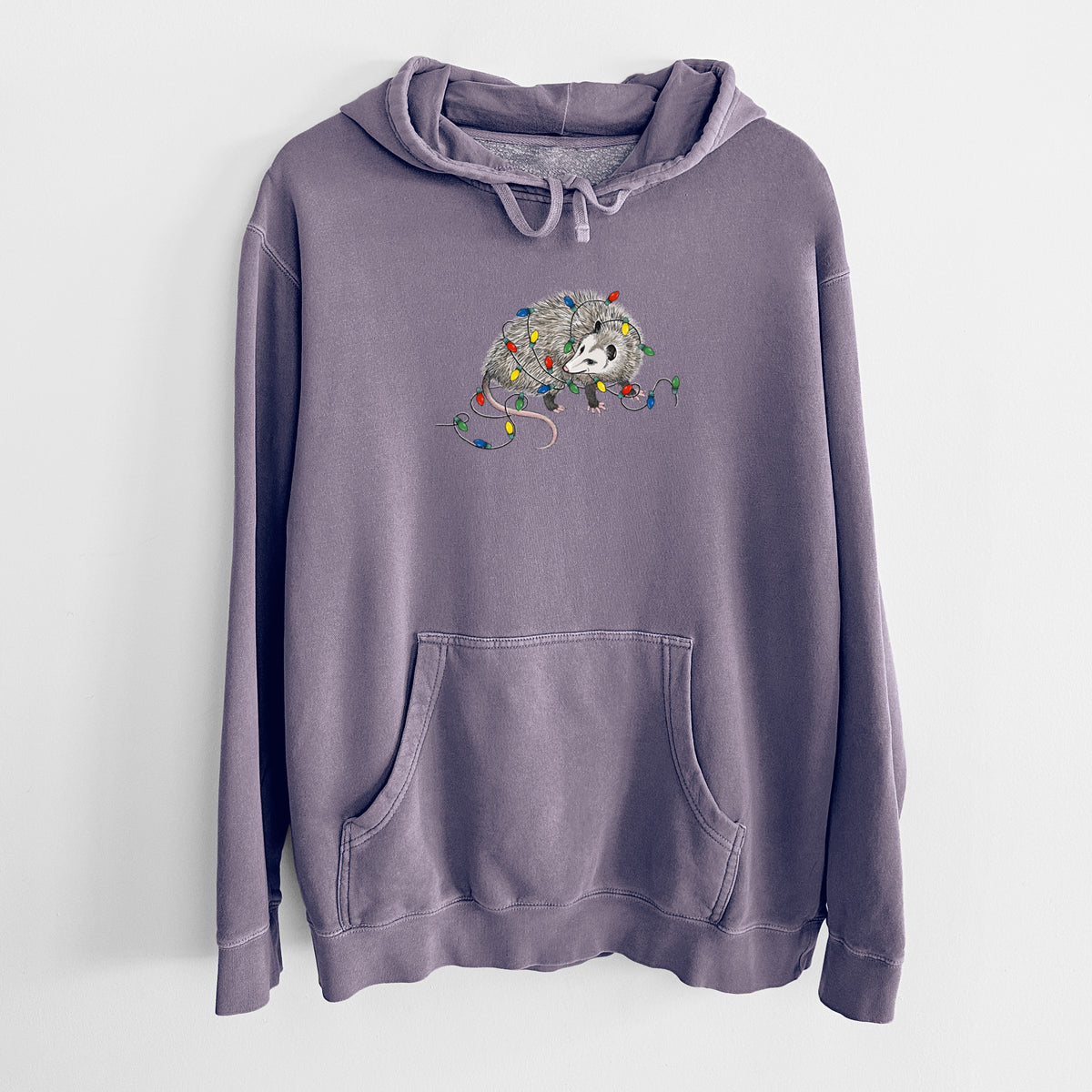 Plum purple pigment dyed hoodie laid flat, printed with a black ink opossum tangled in a string of colorful holiday lights.