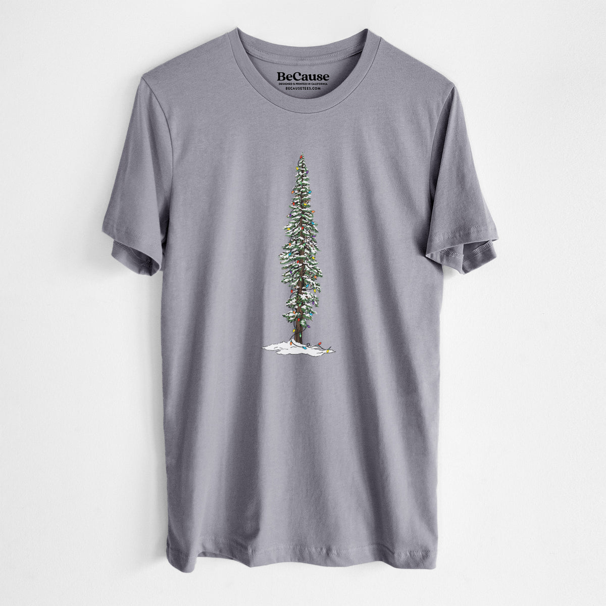 Storm grey lightweight cotton t-shirt laid flat, printed with a full-color illustration of a tall redwood tree dusted with snow and strung with holiday lights.