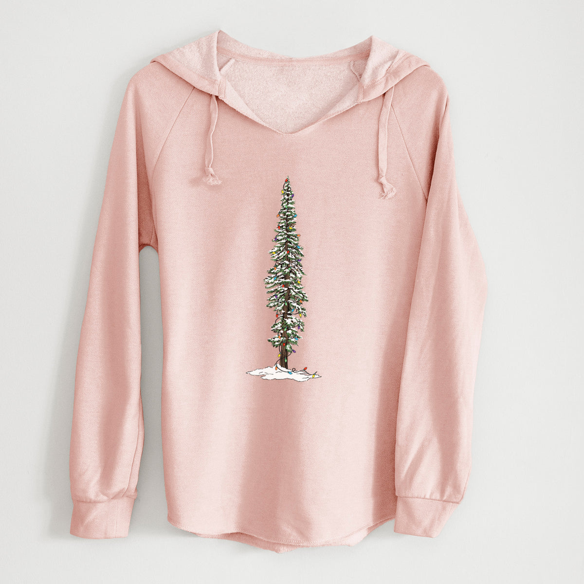Blush pink women's Cali Wave hooded sweatshirt laid flat, printed with a full-color illustration of a tall redwood tree dusted with snow and strung with holiday lights.