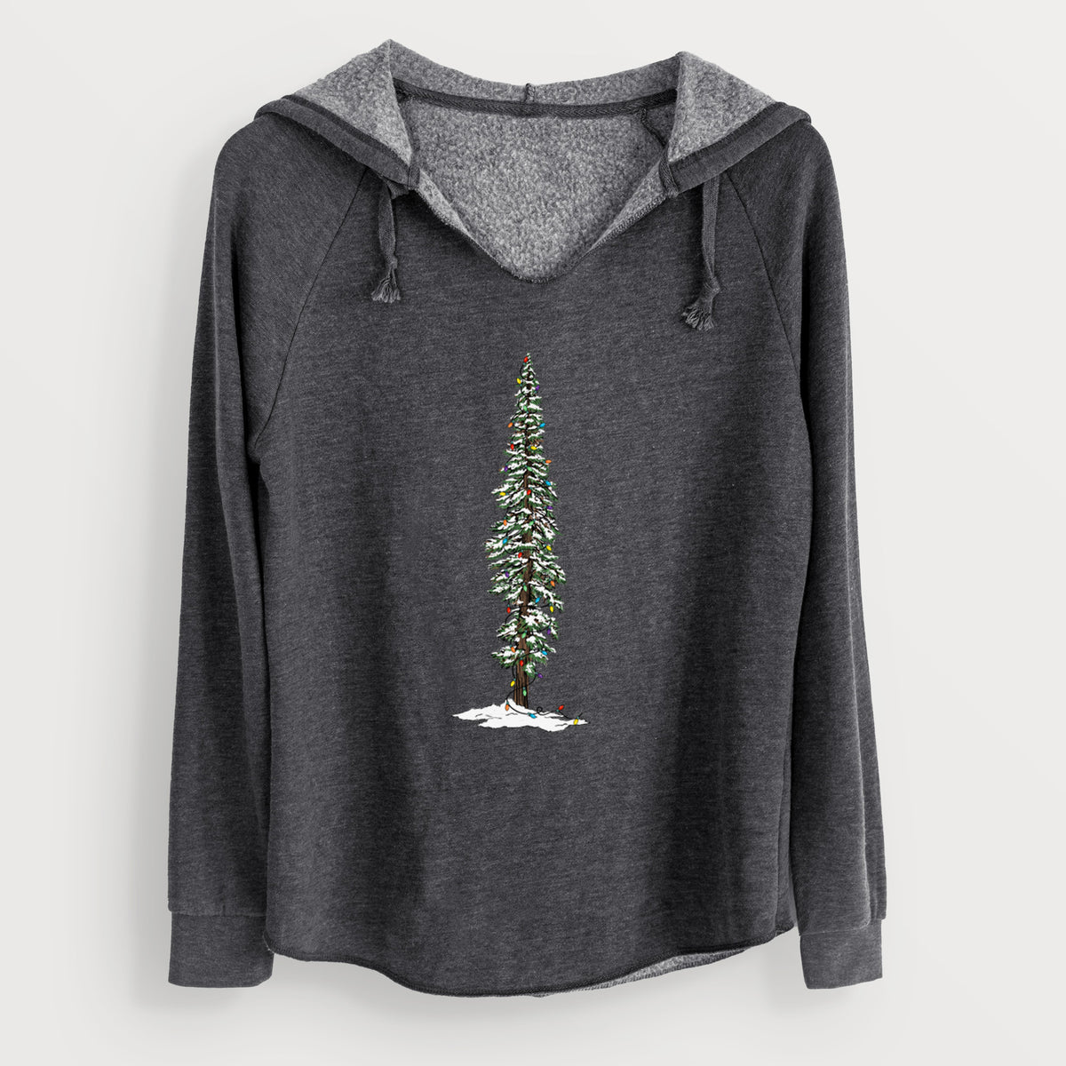 Charcoal grey women's Cali Wave hooded sweatshirt laid flat, printed with a full-color illustration of a tall redwood tree dusted with snow and strung with holiday lights.