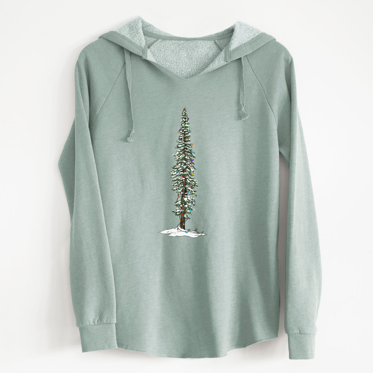 Sage green women's Cali Wave hooded sweatshirt laid flat, printed with a full-color illustration of a tall redwood tree dusted with snow and strung with holiday lights.