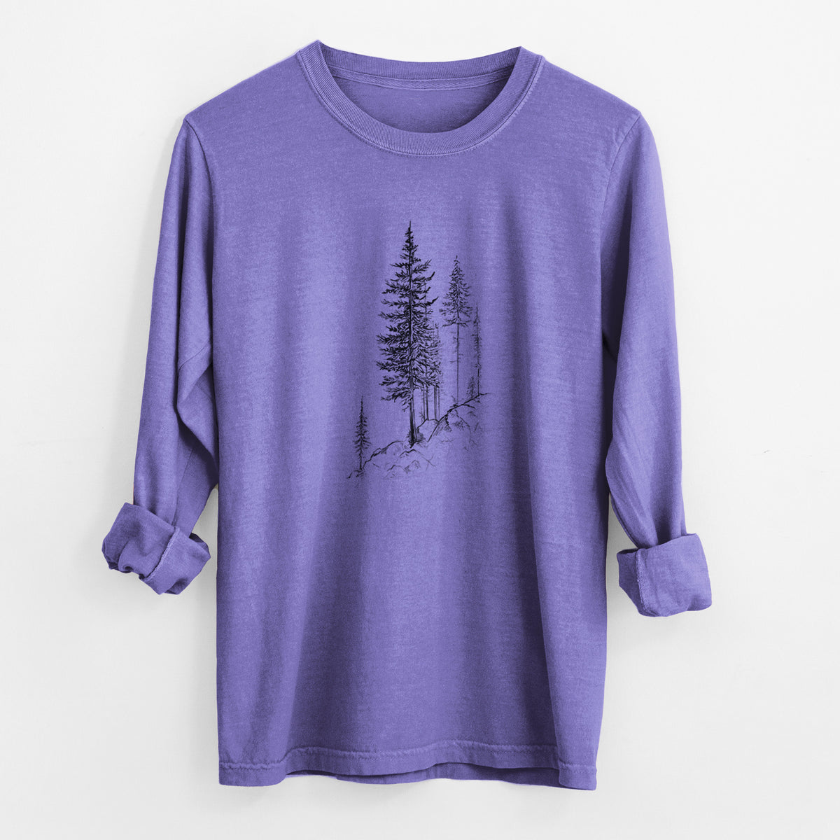 Violet purple Comfort Colors long sleeve shirt laid flat with the cuffs rolled, printed with a black ink illustration of tall pine trees growing from a rocky cliff.