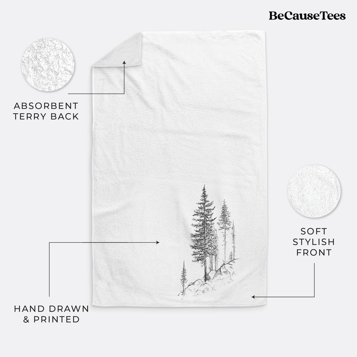 White hand towel printed with a black ink illustration of tall pine trees growing from a rocky cliff.