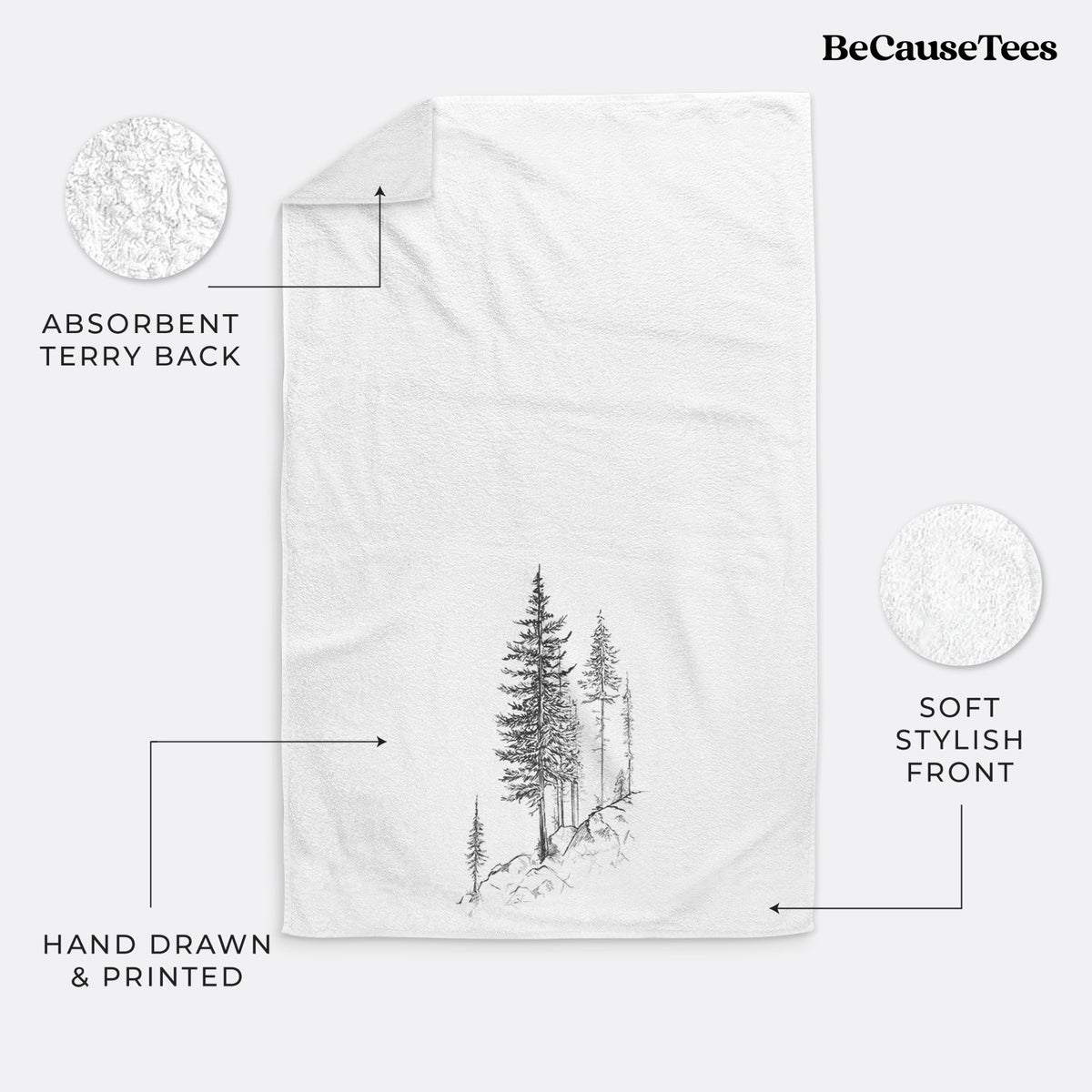 White hand towel printed with a black ink illustration of tall pine trees growing from a rocky cliff.