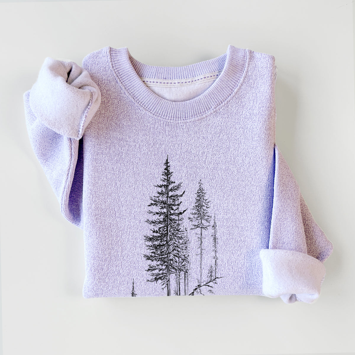 Ice purple knit sweatshirt printed with a black ink illustration of tall pine trees growing from a rocky cliff, styled flat.