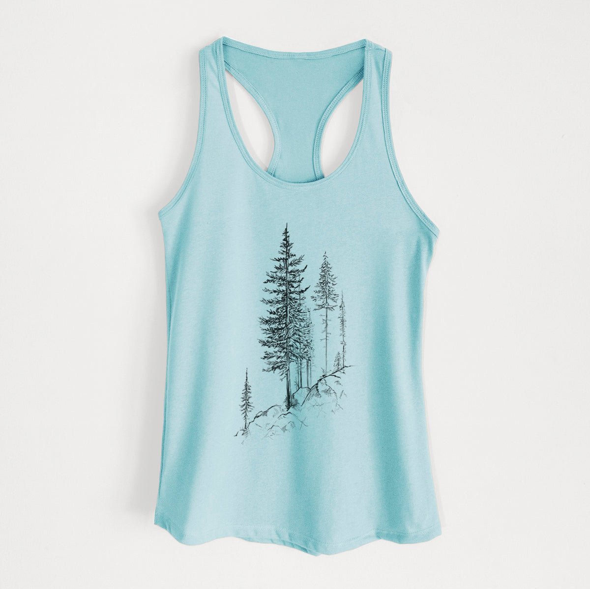 Cancun blue women's racerback tank top laid flat, printed with a black ink illustration of tall pine trees growing from a rocky cliff.
