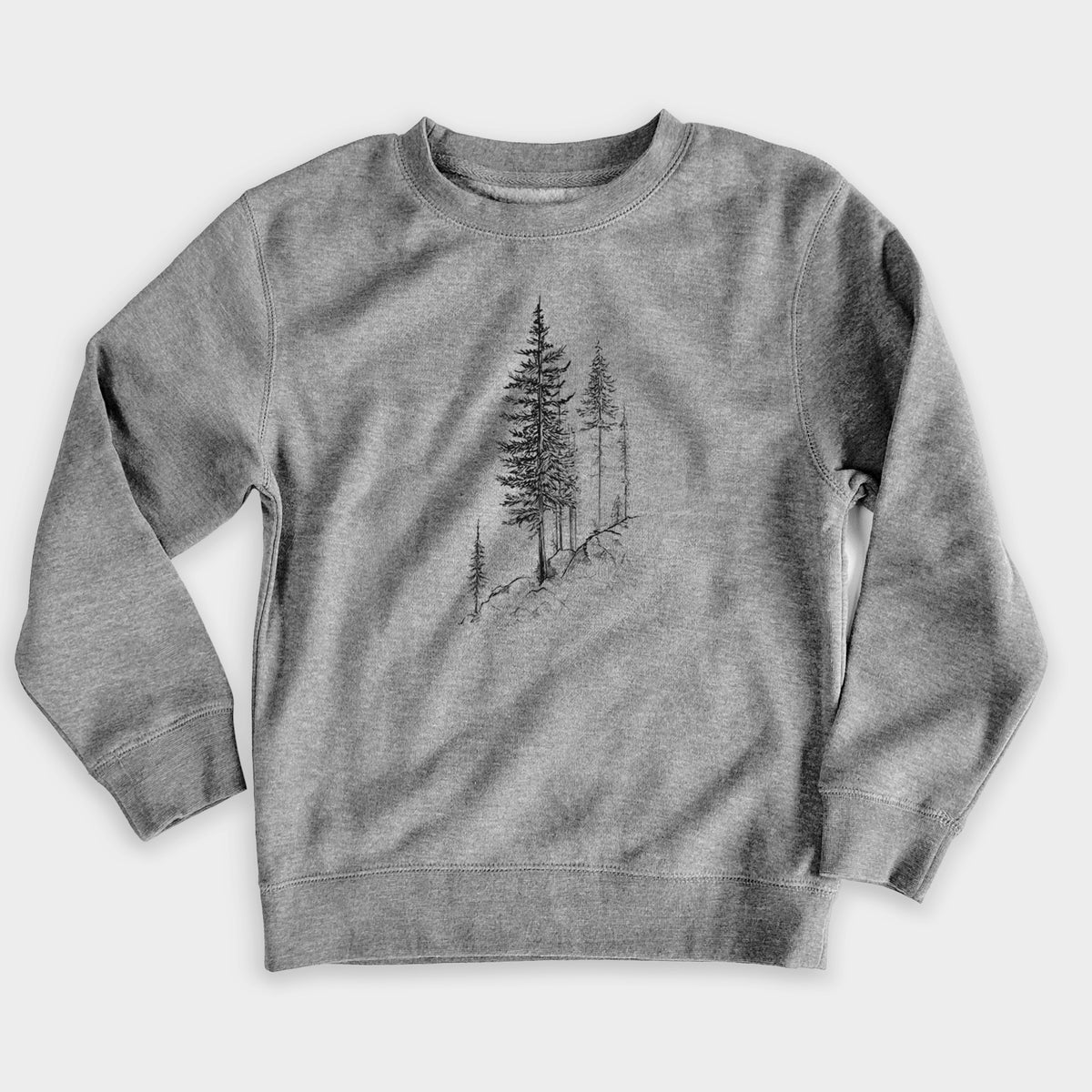 Nickel grey youth crewneck sweatshirt laid flat, printed with a black ink illustration of tall pine trees growing from a rocky cliff.