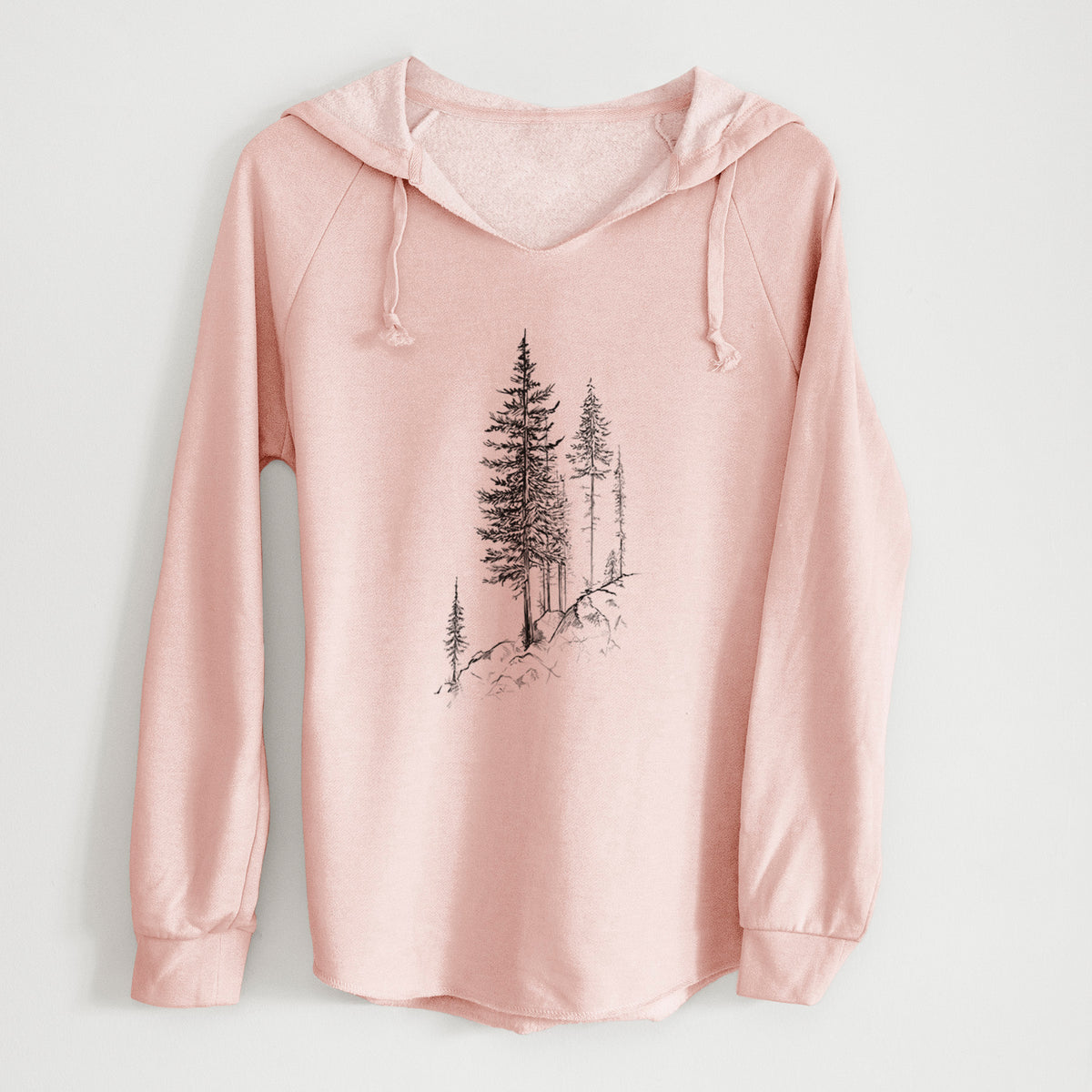 Blush pink women's Cali Wave hooded sweatshirt laid flat, printed with a black ink illustration of tall pine trees growing from a rocky cliff.