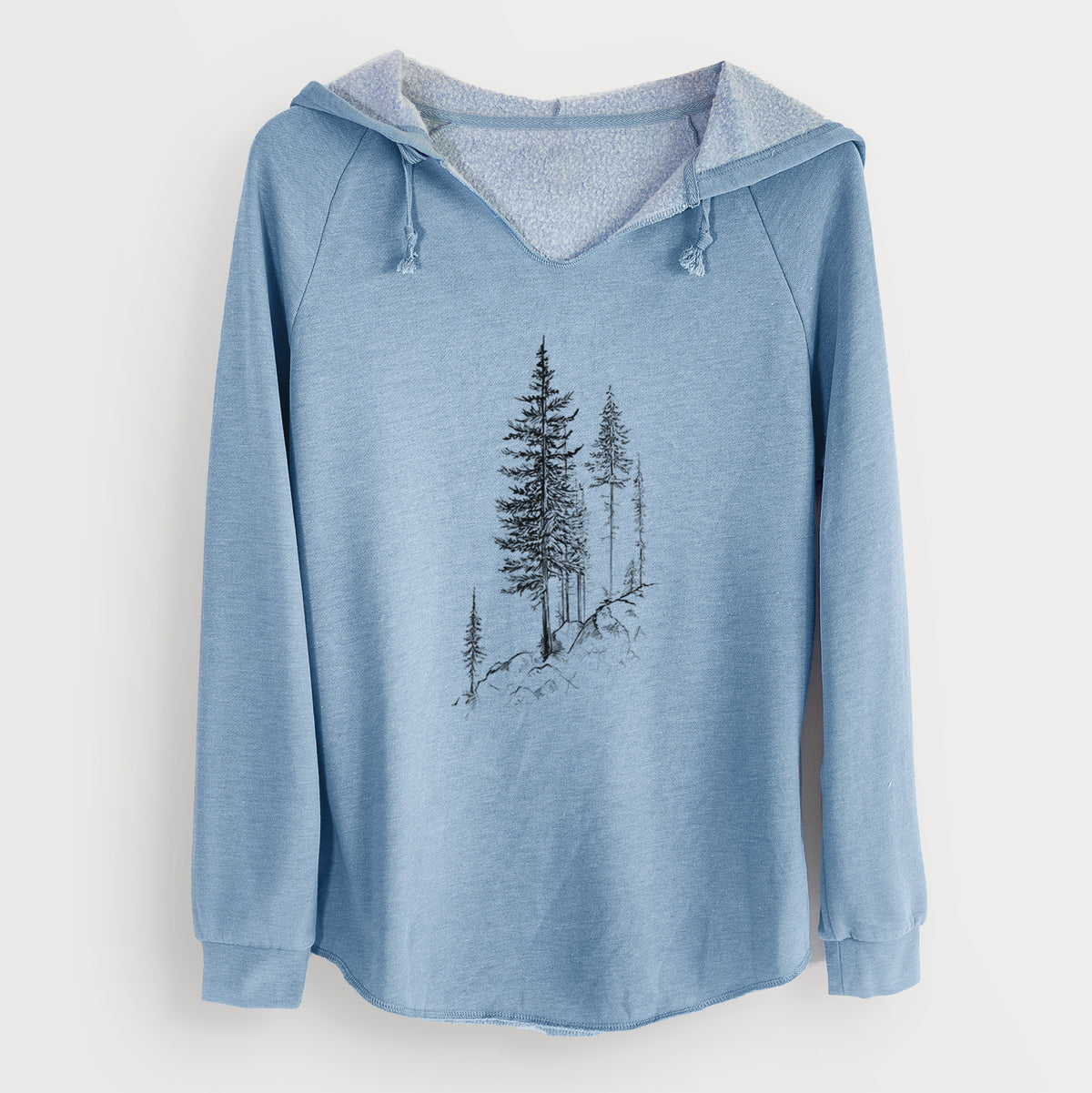 Misty blue women's Cali Wave hooded sweatshirt laid flat, printed with a black ink illustration of tall pine trees growing from a rocky cliff.