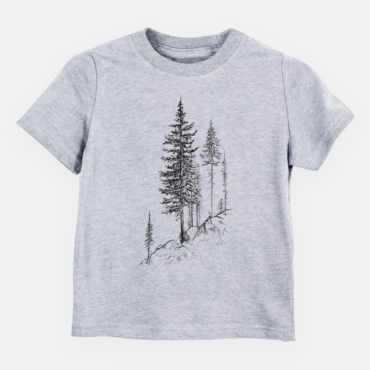 Heather grey toddler t-shirt laid flat, printed with a black ink illustration of tall pine trees growing from a rocky cliff.