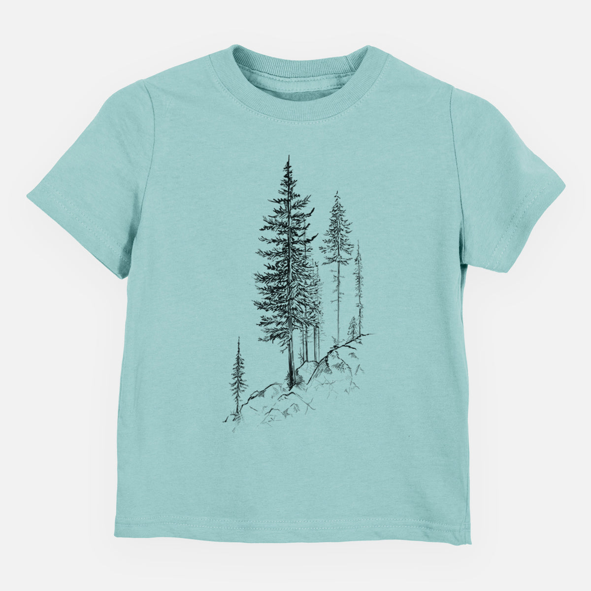 Saltwater toddler t-shirt laid flat, printed with a black ink illustration of tall pine trees growing from a rocky cliff.