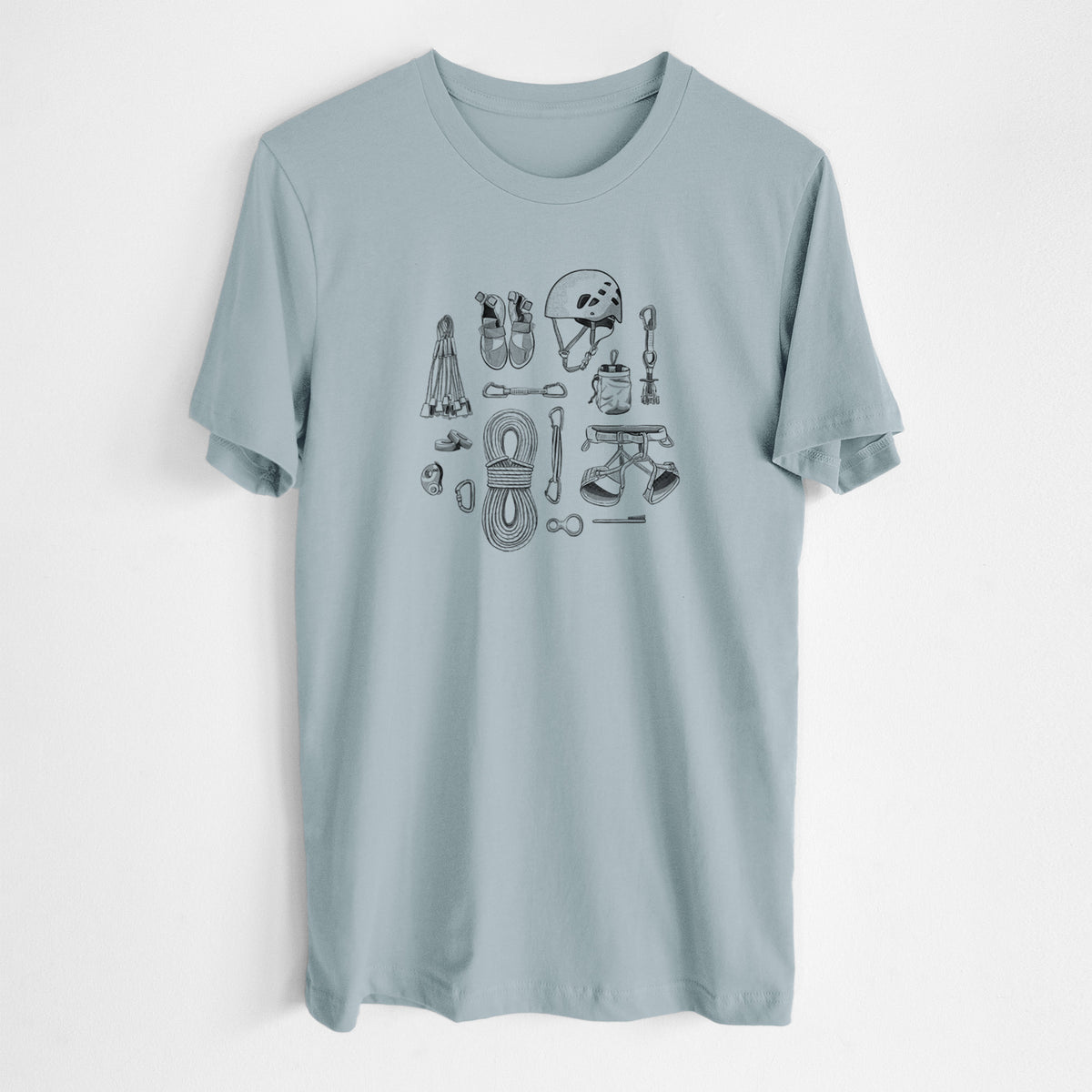 Vintage denim lightweight cotton t-shirt laid flat, printed with a black ink flat lay of rock climbing gear, including a helmet, shoes, rope, harness and carabiners.