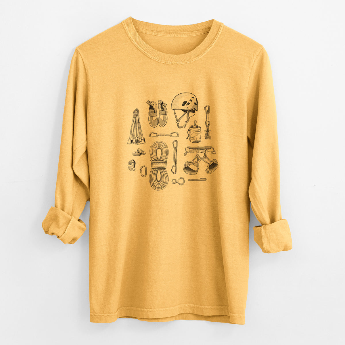 Golden wheat yellow Comfort Colors long sleeve shirt laid flat with the cuffs rolled, printed with a black ink flat lay of rock climbing gear, including a helmet, shoes, rope, harness and carabiners.