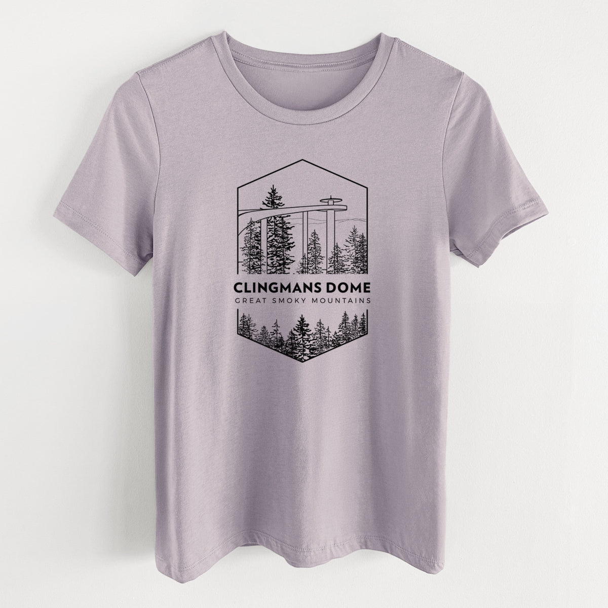 Light violet women's relaxed fit cotton t-shirt laid flat, printed with a black line art badge of the Clingmans Dome observation tower above a pine forest, with the words Clingmans Dome, Great Smoky Mountains.