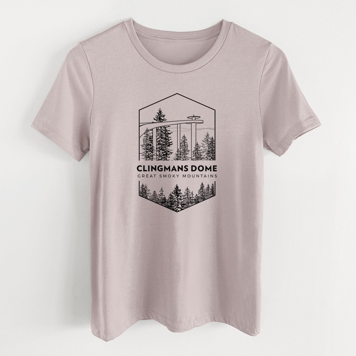 Pink gravel women's relaxed fit cotton t-shirt laid flat, printed with a black line art badge of the Clingmans Dome observation tower above a pine forest, with the words Clingmans Dome, Great Smoky Mountains.