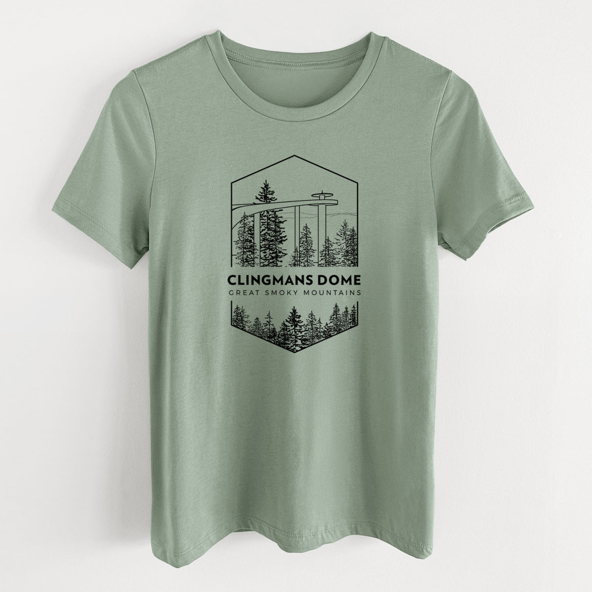 Sage green women's relaxed fit cotton t-shirt laid flat, printed with a black line art badge of the Clingmans Dome observation tower above a pine forest, with the words Clingmans Dome, Great Smoky Mountains.