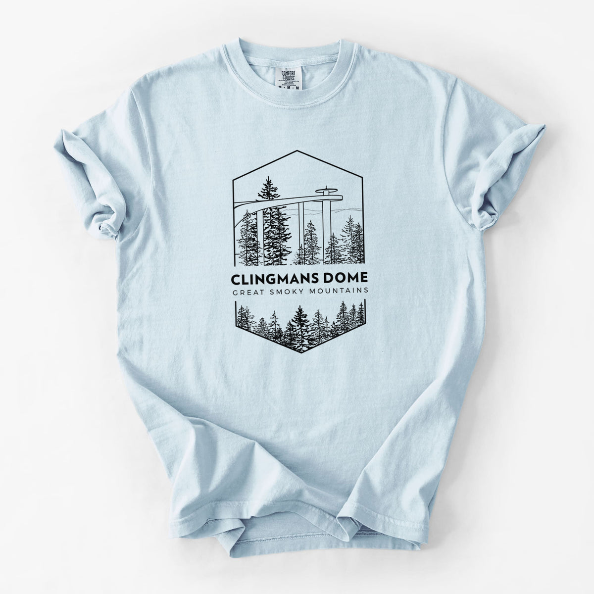 Chambray blue Comfort Colors t-shirt laid flat, printed with a black line art badge of the Clingmans Dome observation tower above a pine forest, with the words Clingmans Dome, Great Smoky Mountains.