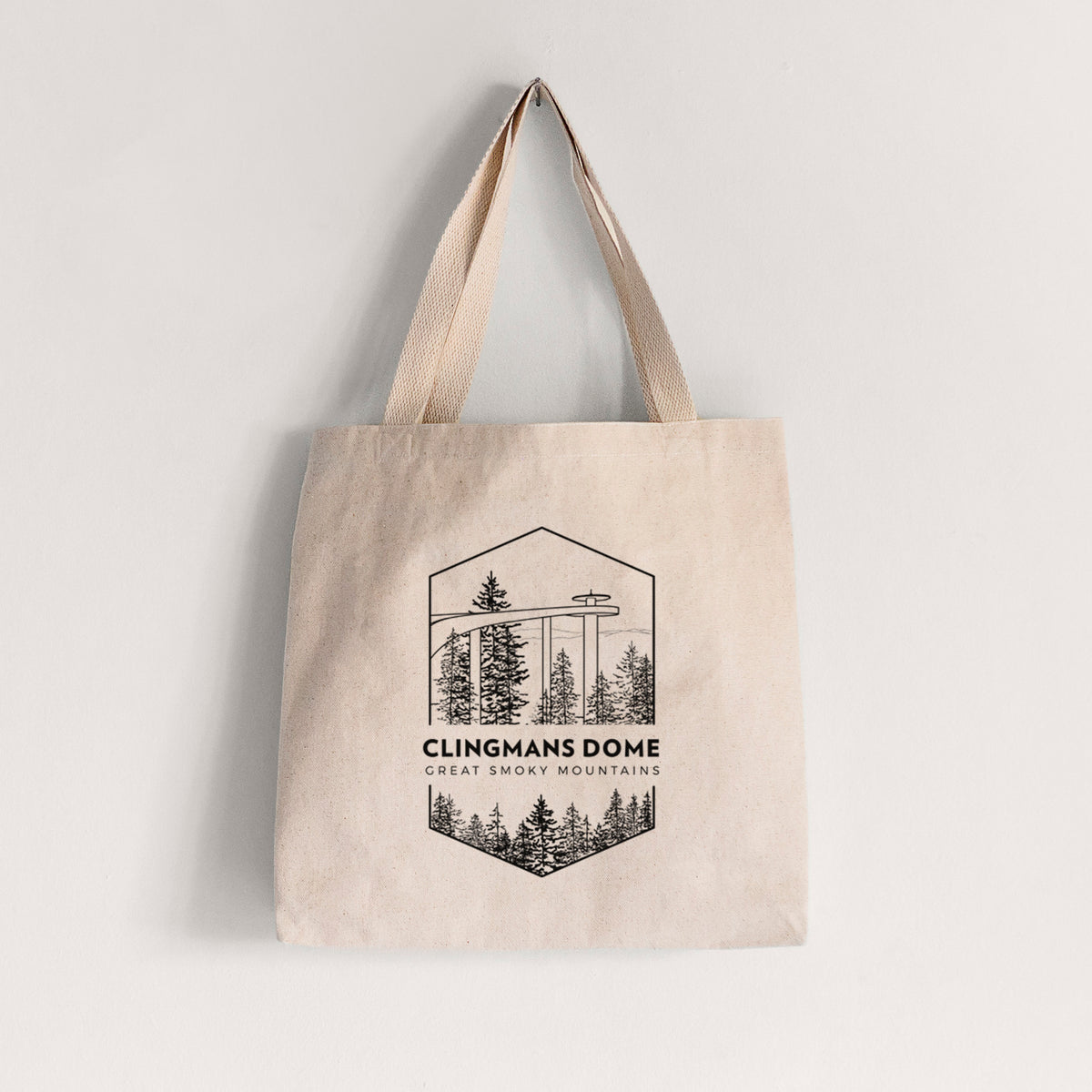 Natural canvas tote bag printed with a black line art badge of the Clingmans Dome observation tower above a pine forest, with the words Clingmans Dome, Great Smoky Mountains.