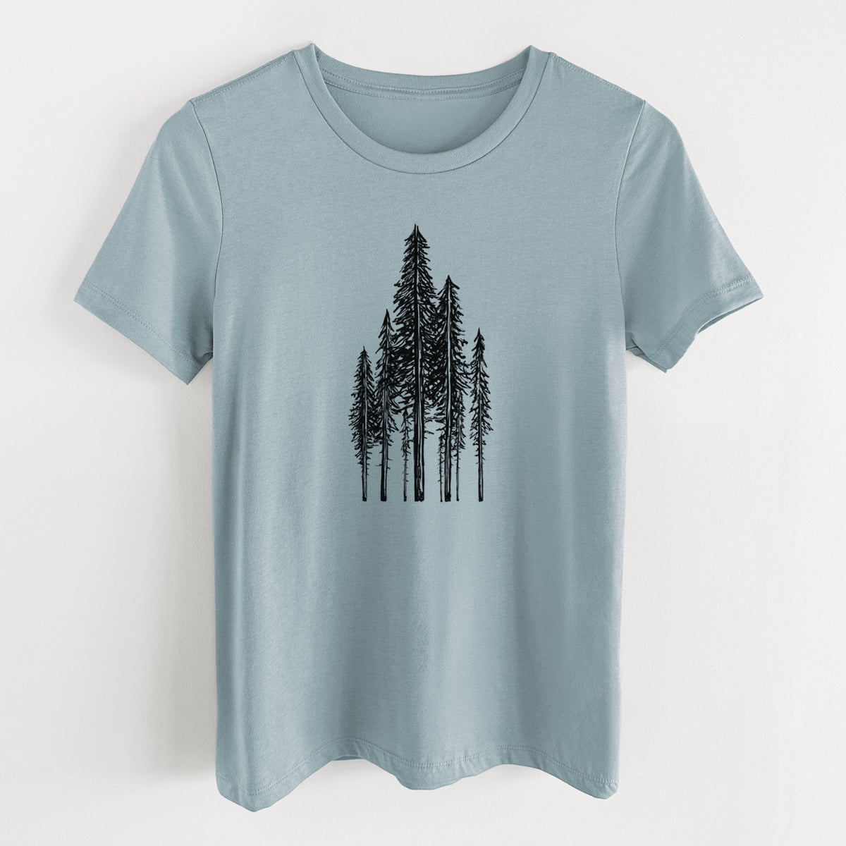Vintage denim women's relaxed fit cotton t-shirt laid flat, printed with a black ink illustration of a stand of tall coastal redwood trees with slender trunks and layered branches.