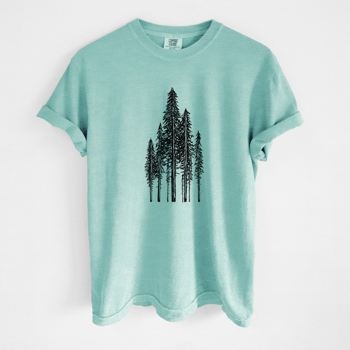 Chalky mint Comfort Colors t-shirt laid flat, printed with a black ink illustration of a stand of tall coastal redwood trees with slender trunks and layered branches.