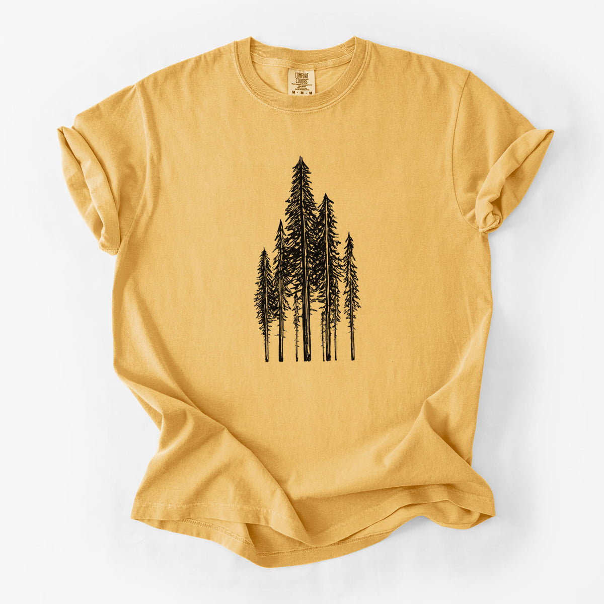 Golden wheat yellow Comfort Colors t-shirt laid flat, printed with a black ink illustration of a stand of tall coastal redwood trees with slender trunks and layered branches.