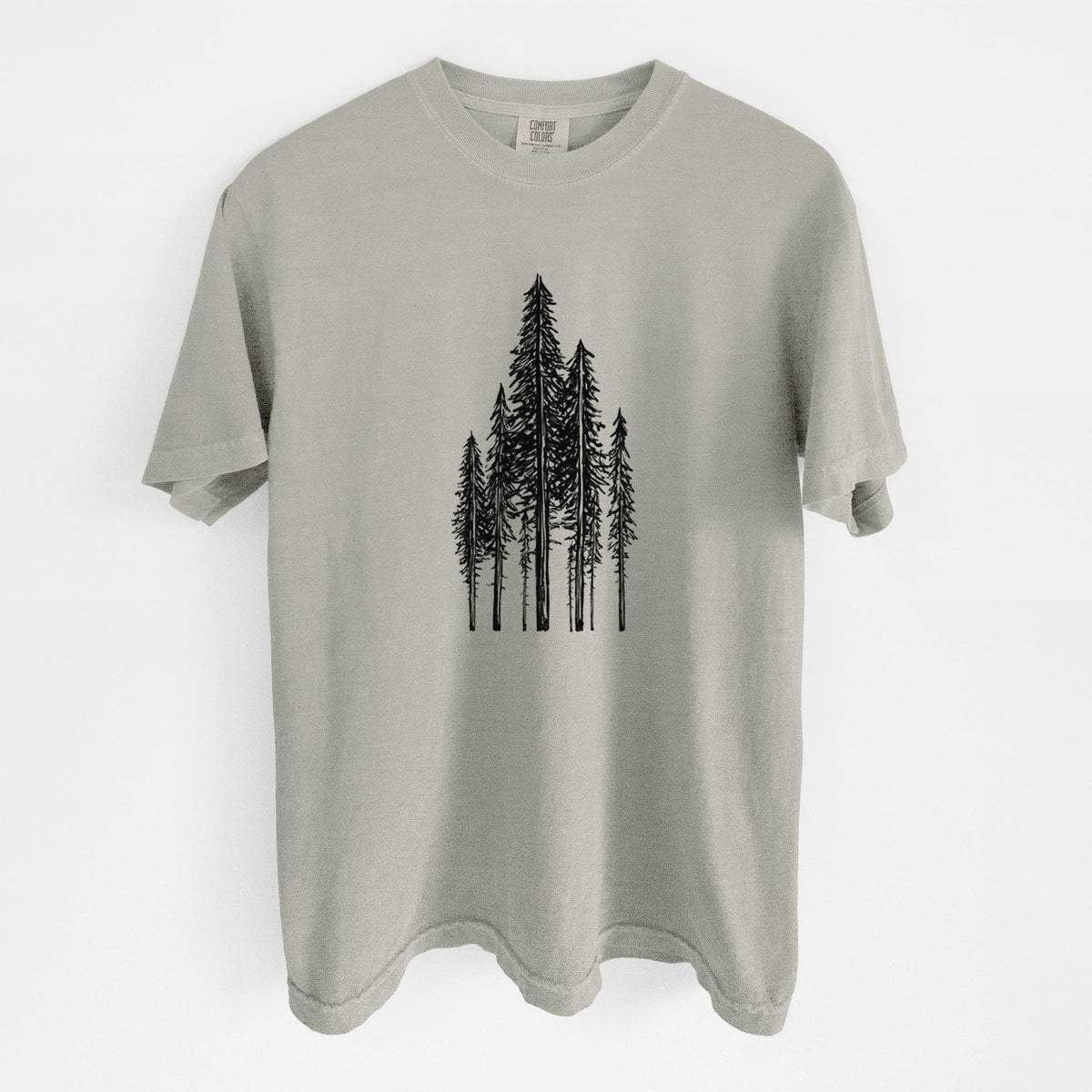 Sandstone beige Comfort Colors t-shirt laid flat, printed with a black ink illustration of a stand of tall coastal redwood trees with slender trunks and layered branches.