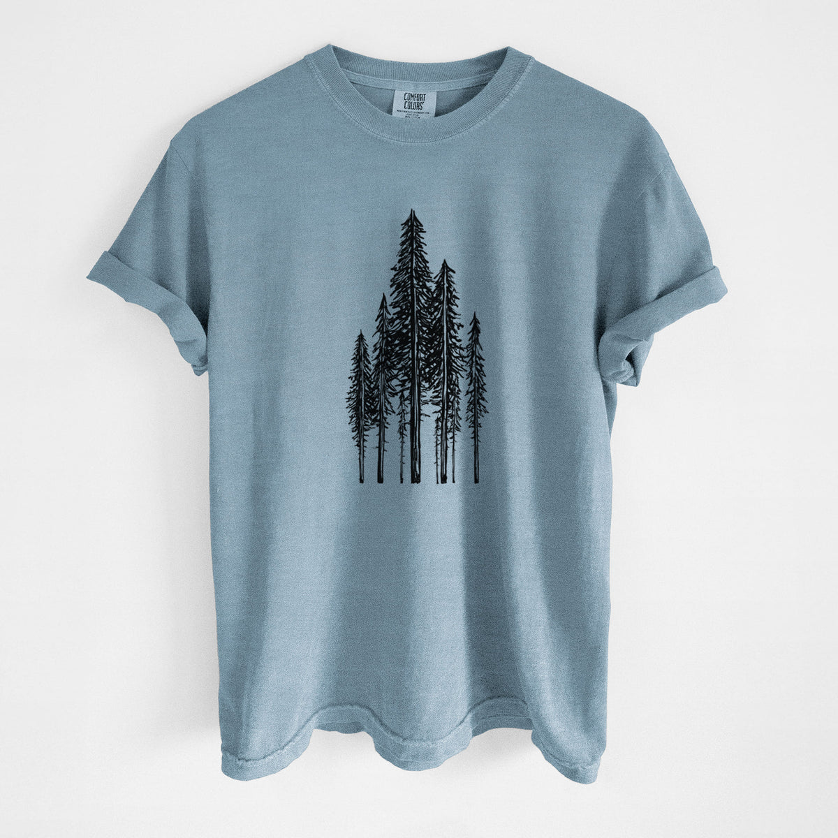 Steel blue Comfort Colors t-shirt laid flat, printed with a black ink illustration of a stand of tall coastal redwood trees with slender trunks and layered branches.