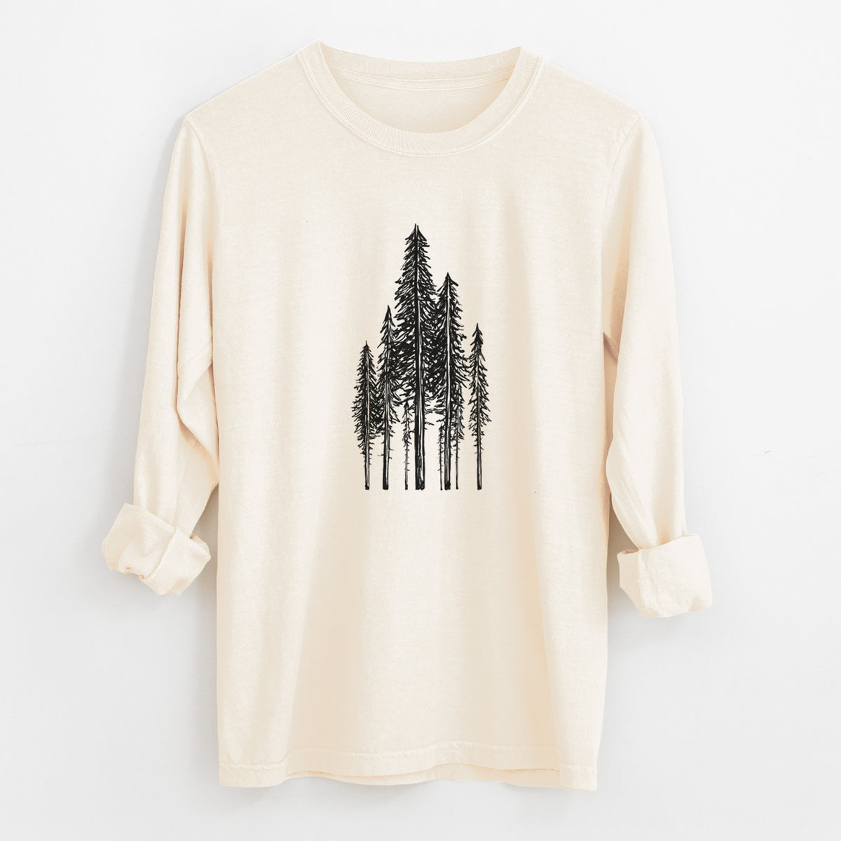 Ivory Comfort Colors long sleeve shirt laid flat with the cuffs rolled, printed with a black ink illustration of a stand of tall coastal redwood trees with slender trunks and layered branches.